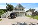 Charming raised beach house with a double garage, spacious driveway, and a welcoming front porch at 1625 Teal Marsh Rd, Charleston, SC 29412