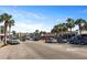 Street view of a bustling street lined with palm trees and a mix of shops and restaurants at 1625 Teal Marsh Rd, Charleston, SC 29412