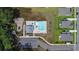 Aerial view of community pool, playground, parking, and surrounding homes with manicured lawns at 2064 Parish House Cir, Johns Island, SC 29455