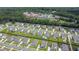 Community aerial view showcasing houses, a high school, and green spaces with trees and sports fields at 2064 Parish House Cir, Johns Island, SC 29455