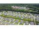 Community aerial view showcasing houses, a high school, and green spaces with trees and sports fields at 2064 Parish House Cir, Johns Island, SC 29455