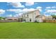 Expansive backyard with a well-maintained lawn, screened-in porch, and privacy fence at 2064 Parish House Cir, Johns Island, SC 29455