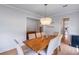 Bright dining room with a contemporary chandelier, large windows, and seating for eight at 2064 Parish House Cir, Johns Island, SC 29455