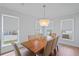 Bright dining room with a contemporary chandelier, large windows, and seating for eight at 2064 Parish House Cir, Johns Island, SC 29455