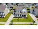 Aerial view of a two-story home with a well-maintained front lawn, attached garage, and inviting curb appeal at 2064 Parish House Cir, Johns Island, SC 29455
