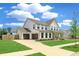 Spacious two-story home with a two-car garage, manicured lawn, and lovely front porch at 2064 Parish House Cir, Johns Island, SC 29455