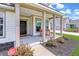 Inviting front porch showcases decorative columns, rocking chairs, and a welcoming entrance to the home at 2064 Parish House Cir, Johns Island, SC 29455