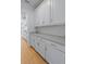 The kitchen features gray countertops, and classic white cabinetry offering a clean design at 2064 Parish House Cir, Johns Island, SC 29455