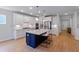 Bright kitchen features a large island with seating, white cabinets, stainless appliances, and modern lighting at 2064 Parish House Cir, Johns Island, SC 29455
