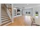 Bright living room featuring custom built-ins, fireplace, and stair access at 2064 Parish House Cir, Johns Island, SC 29455