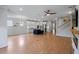Open concept living room features hardwood floors, ceiling fan, and a seamless flow into the modern kitchen at 2064 Parish House Cir, Johns Island, SC 29455