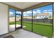 View from the screened-in porch reveals a well-maintained lawn, emphasizing outdoor living and relaxation at 2064 Parish House Cir, Johns Island, SC 29455