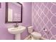 Charming powder room with decorative wallpaper, a pedestal sink, and modern fixtures at 209 Parkwood Vista Way, Summerville, SC 29486