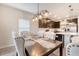 Dining area featuring elegant upholstered chairs and a view of the modern kitchen at 209 Parkwood Vista Way, Summerville, SC 29486