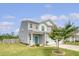 Charming two-story home featuring gray siding, a two-car garage, and a well-manicured front yard at 209 Parkwood Vista Way, Summerville, SC 29486