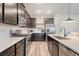 Well-equipped kitchen featuring stainless steel appliances, dark cabinets, and a stylish backsplash at 209 Parkwood Vista Way, Summerville, SC 29486