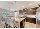 Bright kitchen with stainless steel appliances, an island with barstool seating, and an adjacent dining area at 209 Parkwood Vista Way, Summerville, SC 29486