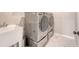 Well-equipped laundry area with modern washer and dryer, a sink, and marble flooring at 209 Parkwood Vista Way, Summerville, SC 29486