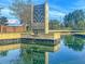 The Cane Bay Plantation water feature is surrounded by lush landscaping under a sunny sky at 209 Parkwood Vista Way, Summerville, SC 29486