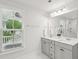 Bright bathroom with dual vanities, large mirror, and neighborhood views at 2267 Kemmerlin St, Johns Island, SC 29455