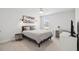 Comfortable bedroom featuring a queen-sized bed, stylish lighting, a window with natural light, and a functional desk area at 2267 Kemmerlin St, Johns Island, SC 29455