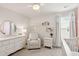 Bright Bedroom with white furniture, including a dresser and armchair, complemented by stylish wall decorations and soft light at 2267 Kemmerlin St, Johns Island, SC 29455