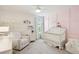 This cozy Bedroom features a white crib, comfortable armchair, and decorative wall art, perfect for a new baby at 2267 Kemmerlin St, Johns Island, SC 29455