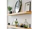 Stylish decorative floating shelves with a variety of plants, frames, and decorative items at 2267 Kemmerlin St, Johns Island, SC 29455