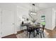 Bright dining area with a modern light fixture, beautiful hardwood floors, and convenient access to the backyard at 2267 Kemmerlin St, Johns Island, SC 29455