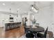 Open-concept dining area with a round table, black chairs, and a view of the adjacent kitchen area at 2267 Kemmerlin St, Johns Island, SC 29455