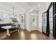 Bright dining room with hardwood floors, white wainscoting, and a modern chandelier fixture at 2267 Kemmerlin St, Johns Island, SC 29455