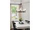 Bright dining room with modern chandelier and view of the outdoor landscape at 2267 Kemmerlin St, Johns Island, SC 29455