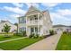 Beautiful two-story home with a double porch, garage, and lush landscaping at 2267 Kemmerlin St, Johns Island, SC 29455