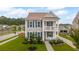Charming two-story home featuring a front porch, balcony, blue shutters, and a well-manicured lawn at 2267 Kemmerlin St, Johns Island, SC 29455