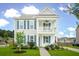 Charming two-story home featuring a double porch, blue shutters, and lush landscaping at 2267 Kemmerlin St, Johns Island, SC 29455