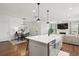 Open kitchen, dining, and living space with hardwood floors and island with seating at 2267 Kemmerlin St, Johns Island, SC 29455