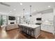 Bright, open-concept kitchen featuring a large center island, white cabinets, and modern stainless steel appliances at 2267 Kemmerlin St, Johns Island, SC 29455