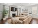 Inviting living room featuring a cozy fireplace, large sectional sofa, and ample natural light from the windows at 2267 Kemmerlin St, Johns Island, SC 29455