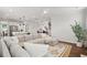 Open-concept living area connecting the kitchen and living room, featuring a large sectional sofa and island seating at 2267 Kemmerlin St, Johns Island, SC 29455