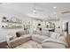 Spacious, open-concept living area with modern furnishings, white walls, and a seamless flow to the kitchen at 2267 Kemmerlin St, Johns Island, SC 29455