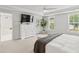 Spacious primary bedroom featuring natural light, tray ceiling, and access to ensuite bathroom at 2267 Kemmerlin St, Johns Island, SC 29455