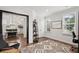 A room featuring a decorative rug, multiple windows, and an open entry to the dining room at 2267 Kemmerlin St, Johns Island, SC 29455