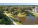 Scenic aerial view of the community pond and walking path, lined with mature trees at 2267 Kemmerlin St, Johns Island, SC 29455