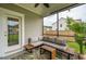 Screened porch with comfortable seating, stylish rug, and view of the yard, perfect for outdoor relaxation at 2267 Kemmerlin St, Johns Island, SC 29455
