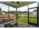 Cozy screened porch with comfortable seating, ceiling fan, and views of the fenced-in backyard at 2267 Kemmerlin St, Johns Island, SC 29455