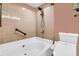 Comfortable bathroom featuring a deep soaking tub with jets, a tiled shower area, and a modern toilet at 250 Little Oak Island Dr, Folly Beach, SC 29439
