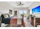 Bedroom with a view of the outdoor patio, a ceiling fan, a television, and a dresser at 250 Little Oak Island Dr, Folly Beach, SC 29439