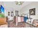 Bedroom with classic style, a bed, art on the walls, a ceiling fan, and a view of the bathroom at 250 Little Oak Island Dr, Folly Beach, SC 29439