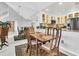 Dining area with wooden table, chairs, and mirror wall adjoining a modern kitchen at 250 Little Oak Island Dr, Folly Beach, SC 29439