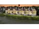 Beautiful waterfront townhomes featuring multiple balconies, lush lawns, and tranquil water views at 250 Little Oak Island Dr, Folly Beach, SC 29439